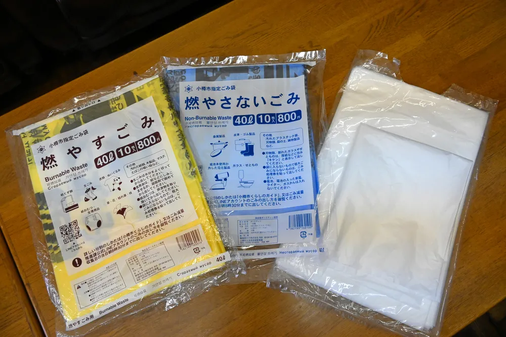 小樽市の指定ごみ袋（左と中央）。在庫不足で15日から右のような市販の袋でも回収を始める