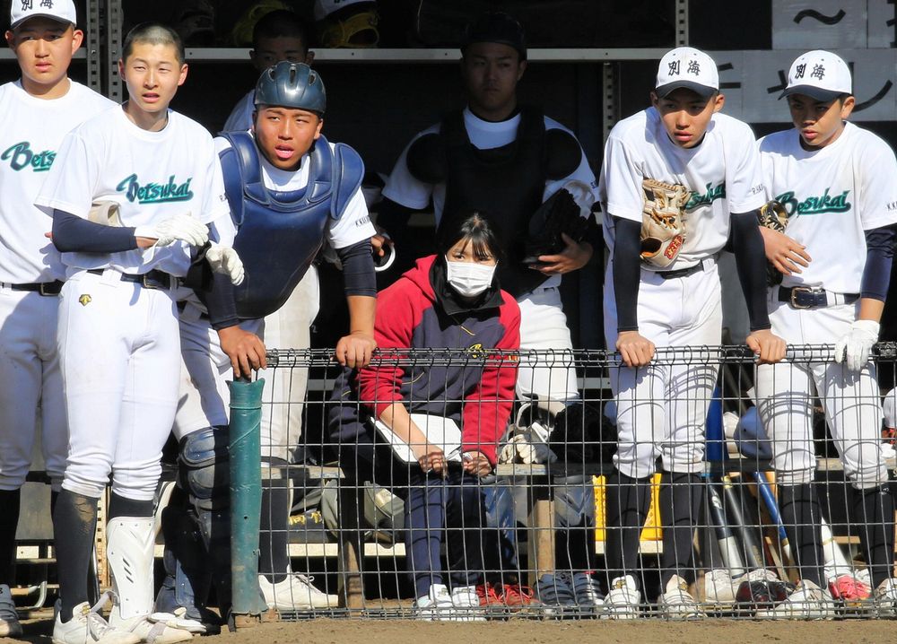 練習試合のベンチで戦況を見つめる中岡さん（中央）。「甲子園が決まってから、みんな顔つきが良くなった」＝３月３日、水戸市内