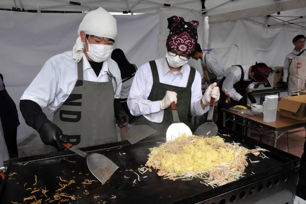 道の駅「スタープラザ芦別」で昨秋開催された「高校生カフェ」でオムレツを載せた焼きそばを作る生徒たち。本年度から任意団体に主催が変わる