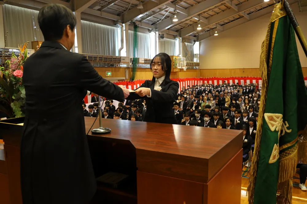 岩見沢西高の伊勢一哉校長から卒業証書を受け取る生徒