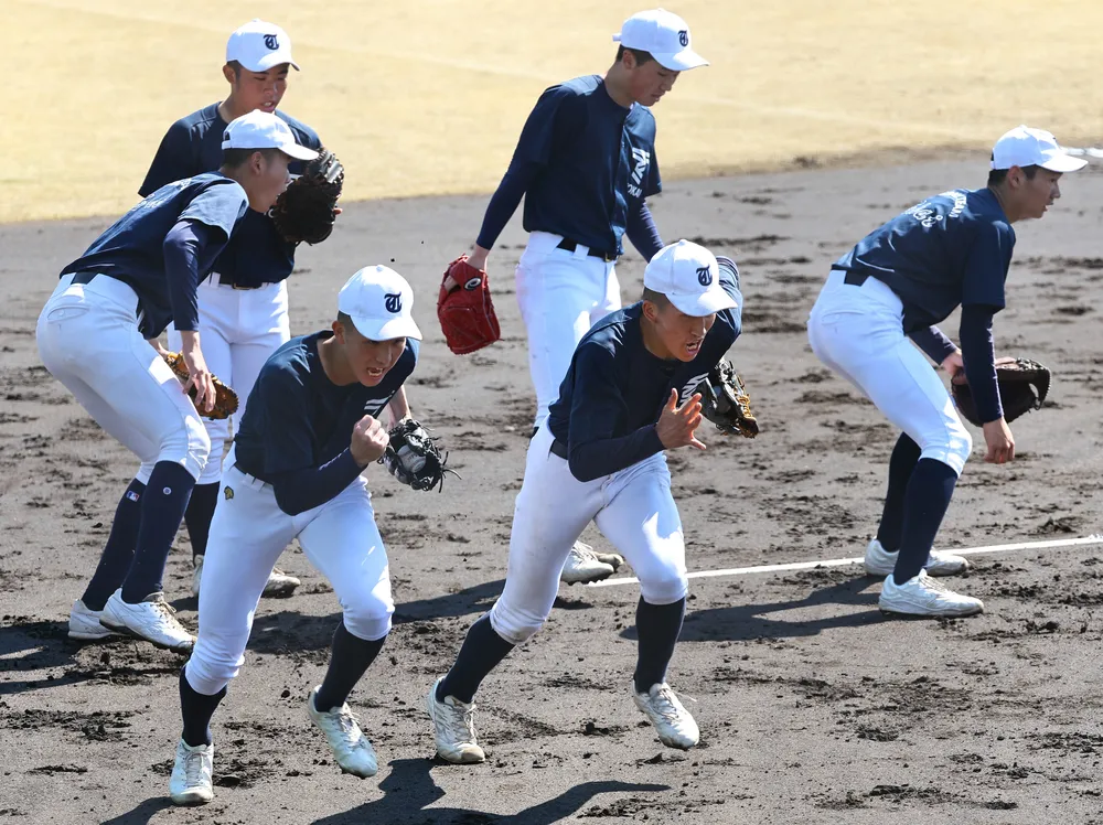 グラブを持ち短距離ダッシュする東海大札幌高の選手たち=18日、豊中市（村本典之撮影）