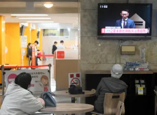 市役所１階で日本ハム球団の会見中継を見ながら、ため息をもらす市民