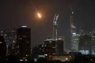 14日、イスラエル中部テルアビブに落下する飛翔（ひしょう）体（AP=共同）